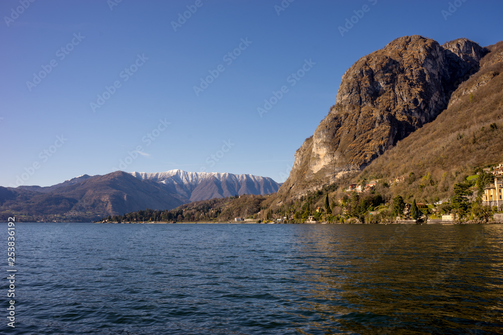 Italy, Menaggio, Lake Como, a large body of water with a mountain in the background
