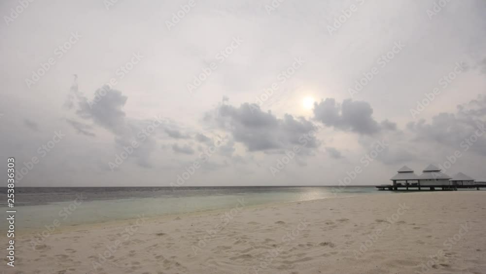 Timelapse of the sun setting in the Maldives over some water huts. Timelapse of the sun setting in the Maldives over some water huts.