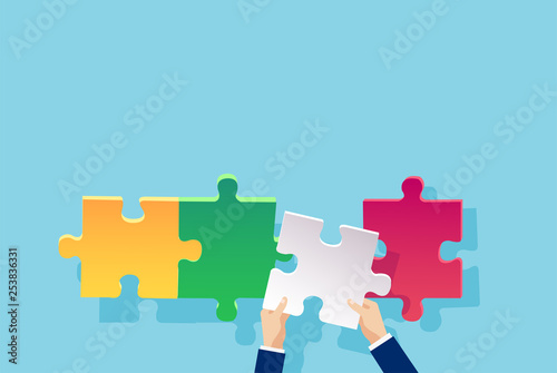 Vector of a businessman hand adding a puzzle piece