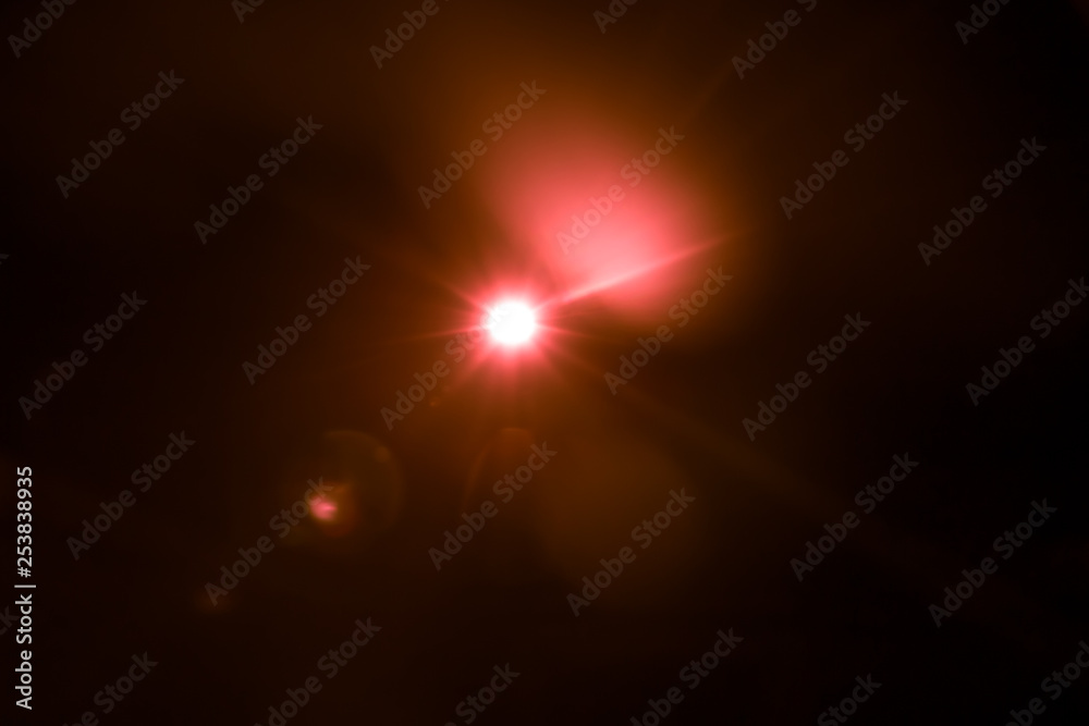 abstract lens flare red light over black background abstract lens flare red light over black background