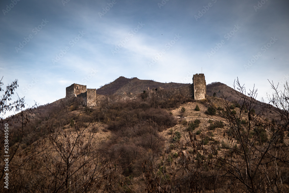 Obraz premium Ruins of medieval castle on top of hill near the river and road. Maglic in Serbia.