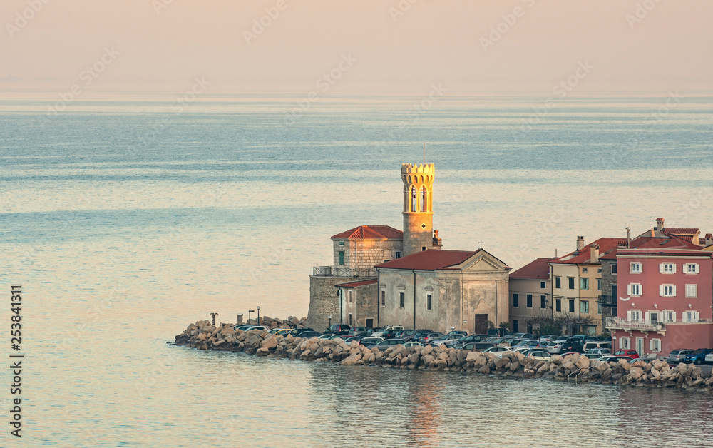 Lighthouse in Piran, Slovenia, lit by early morning sun