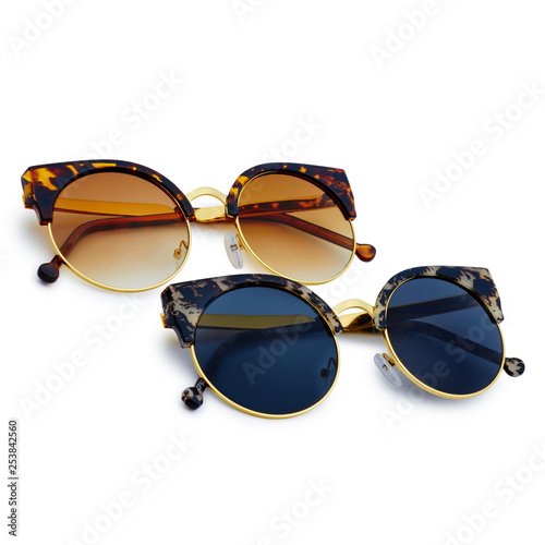Sunglasses with colorful lenses on white background