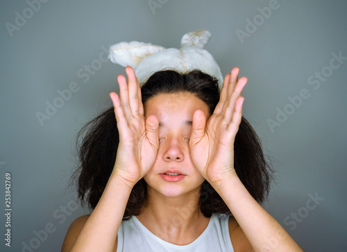 Canvas Print Little cute girl in studio easter celebration concept in bunny ears crying upset