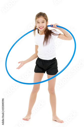 The little girl turns the hoop.