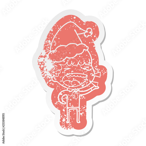 cartoon distressed sticker of a laughing man wearing santa hat