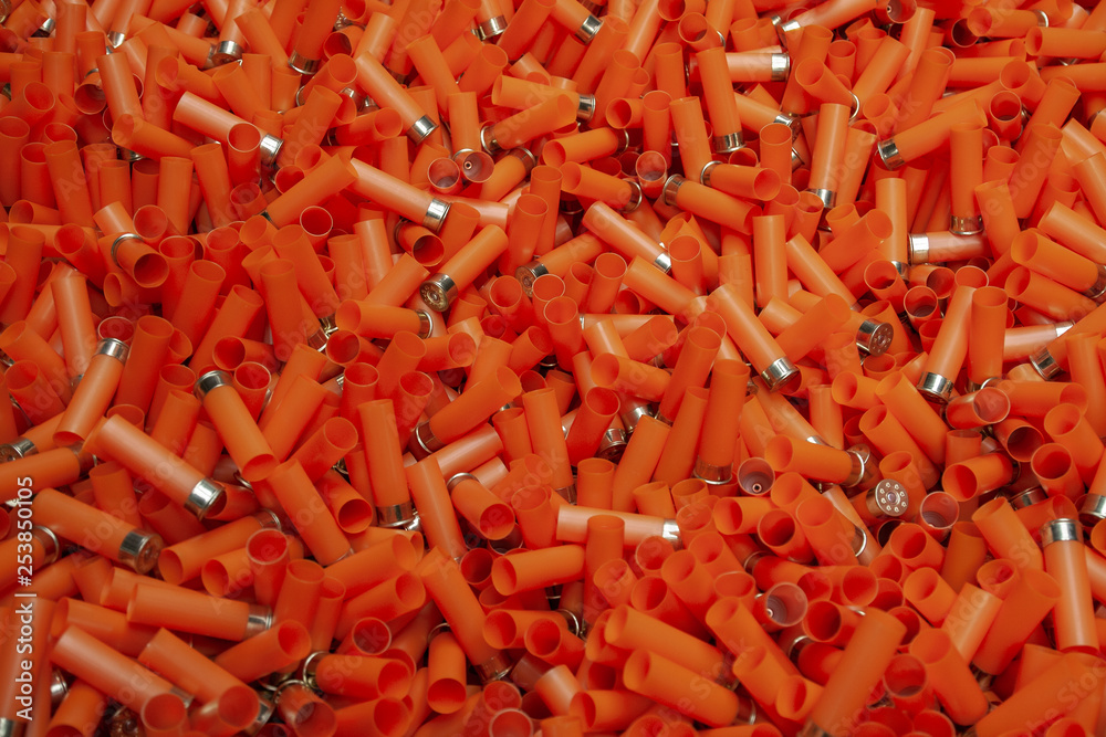 Empty orange shotgun cartridges Stock Photo | Adobe Stock