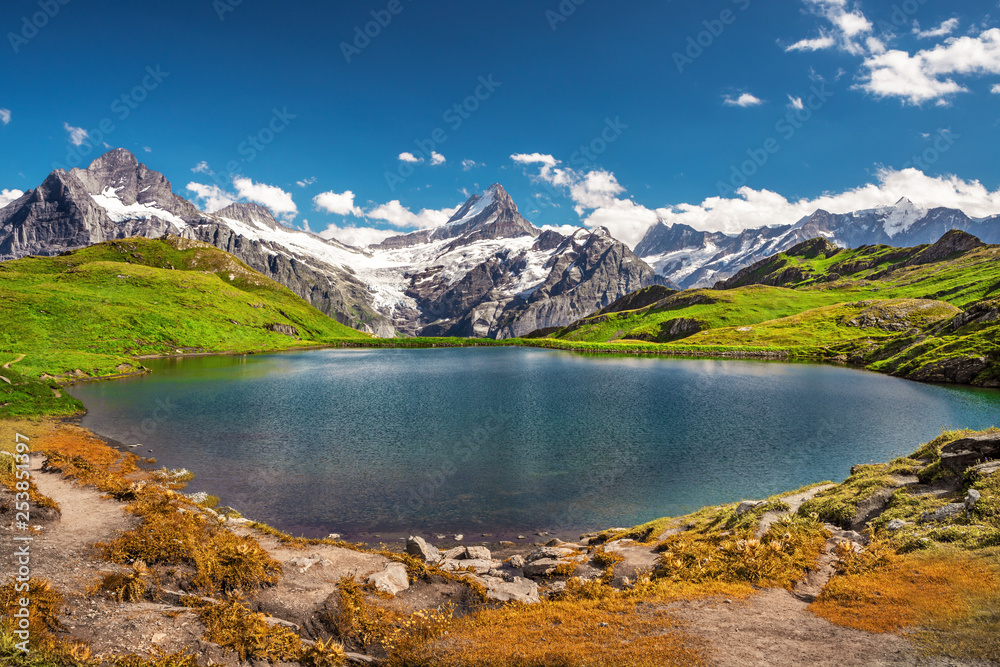 Morning view on Bernese range above Bachalpsee lake with Mounch, Eiger Faulhorn and Reti peaks. Popular tourist attraction. Location place Swiss alps, Grindelwald valley, Europe. Artistic picture.