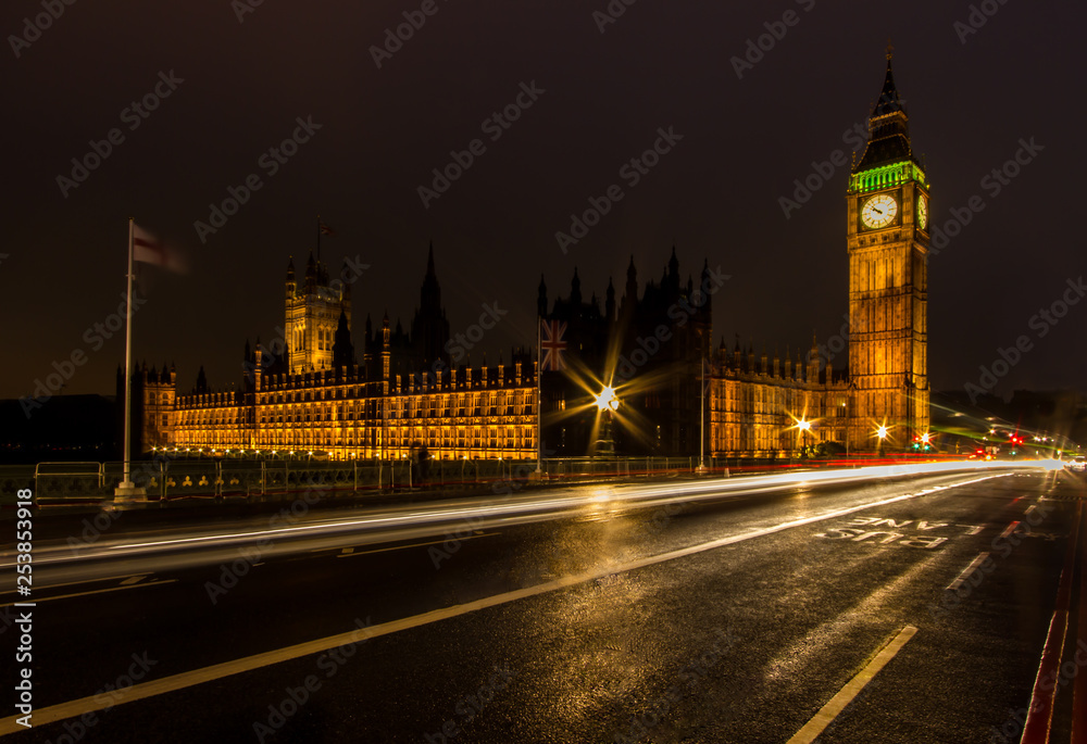 A night long exposure of the House of Parliament and Big Ben along the Westminster Bridge with traffic light trails