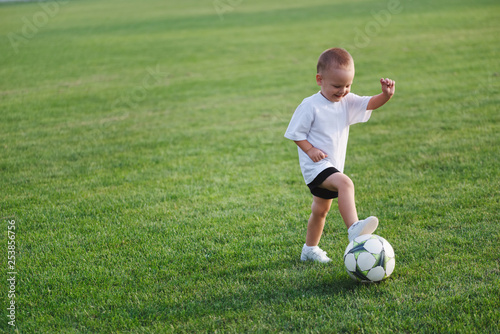 little happy boy on football field © Aliaksei Lasevich