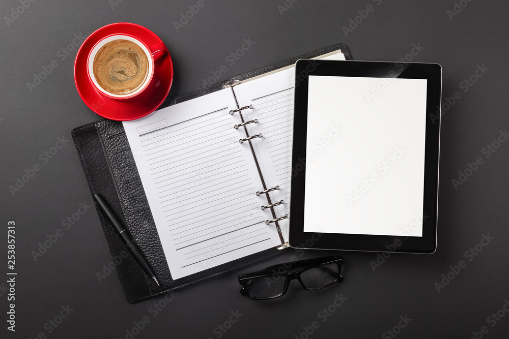 Tablet computer gadget on businessman desk and coffee cup. Top view with copy space Tablet computer gadget on businessman desk and coffee cup. Top view with copy space