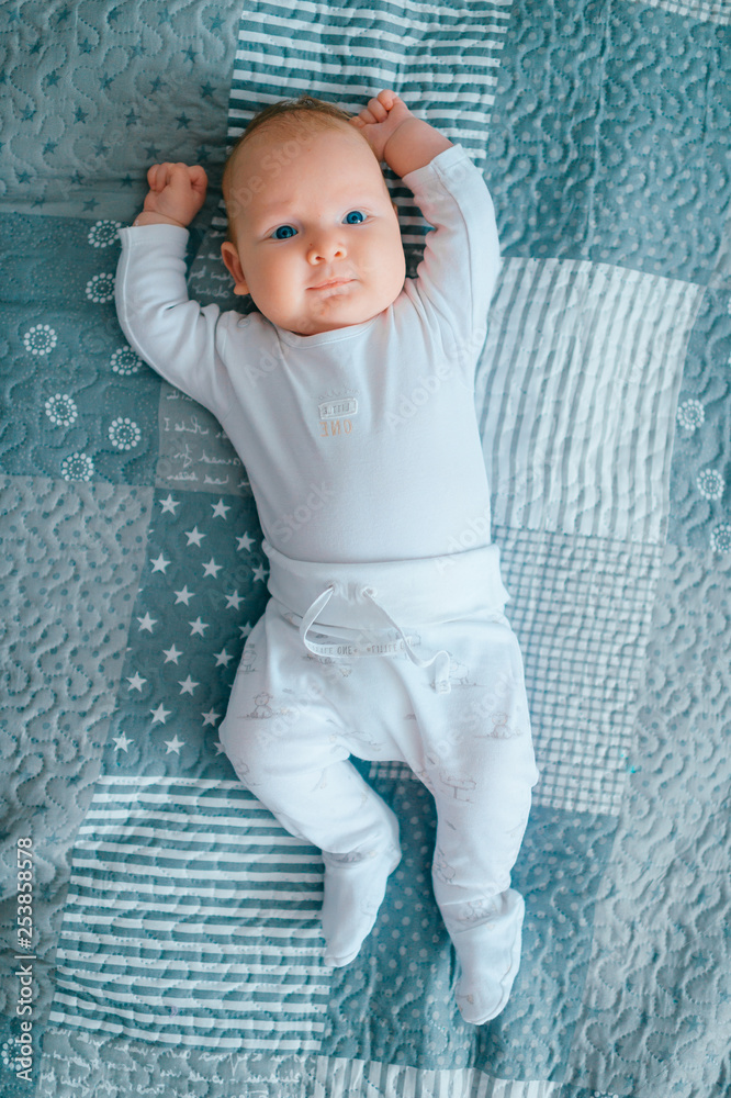 Adorable lovely newborn male baby with blue eyes lifestyle indoor portrait  from above. Cute child with