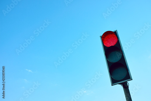 Red Traffic Light Against the Sky