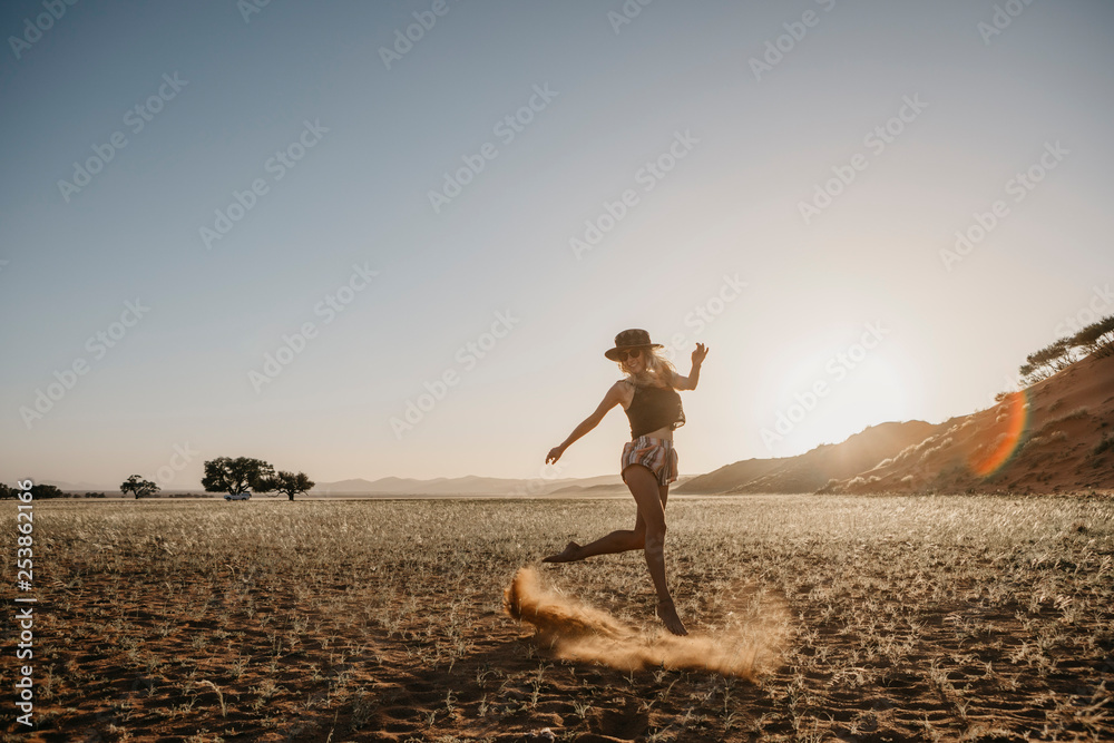 Namibia, Namib desert, Namib-Naukluft National Park, Sossusvlei, woman moving at sunset at Elim Dune