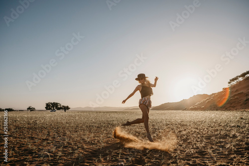 Namibia  Namib desert  Namib-Naukluft National Park  Sossusvlei  woman moving at sunset at Elim Dune