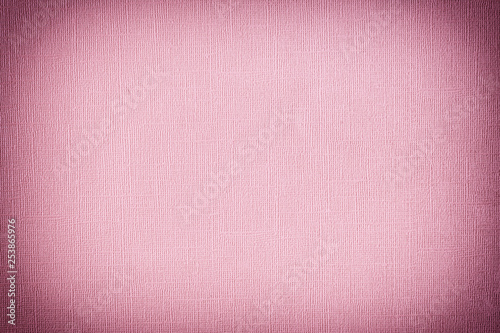 Texture of dark pink paper with unevenness and embossed close-up. Blank background for layouts with vignette.