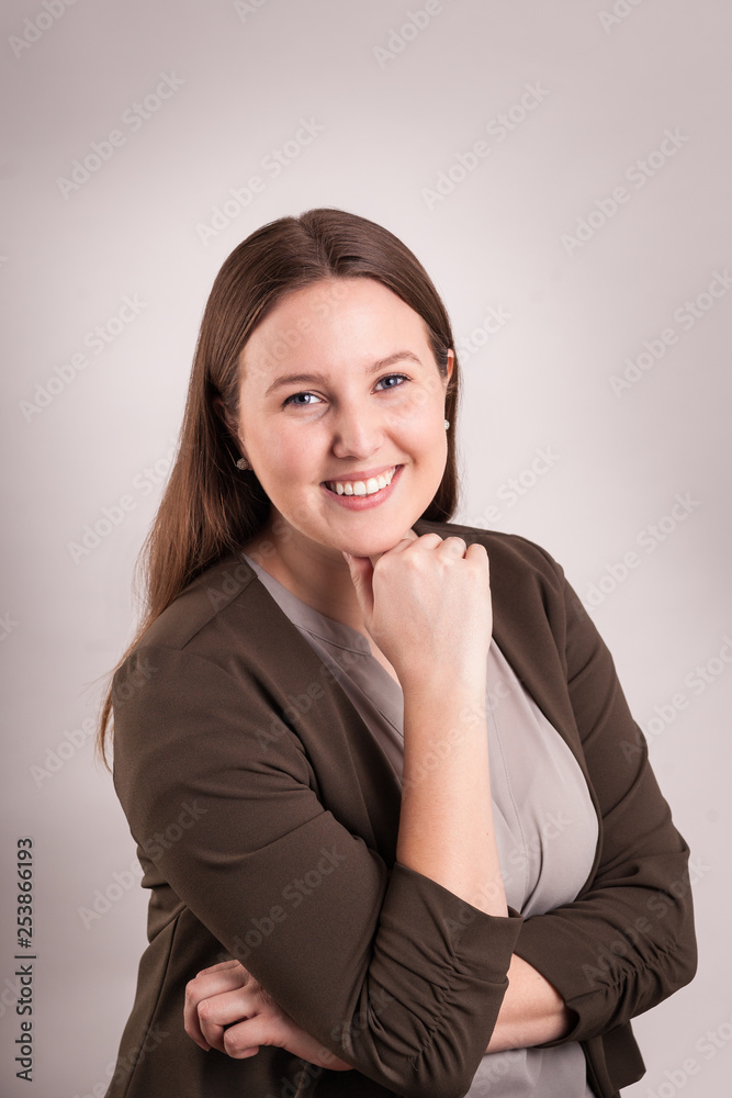 Portrait of a young woman professional head shot hand on chin pretty smile Portrait of a young woman professional head shot hand on chin pretty smile