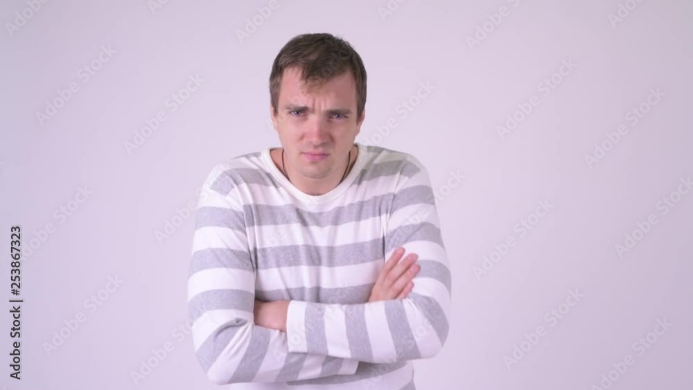 Young angry man doing various gestures while looking furious Young angry man doing various gestures while looking furious