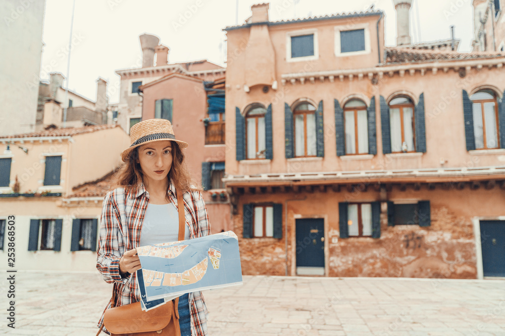 Discovery the Venice. Traveler girl looks at the map of walking, female adventure in Venice, Italy