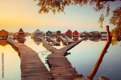Bokod lake, Hungary - The famous floating village with piers and traditional fishing wooden cottages on a autumn evening