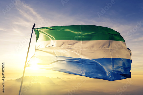 Foto Sierra Leone flag waving on the top sunrise mist fog