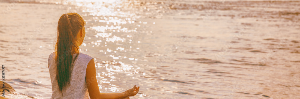 Yoga woman meditating on morning sunrise . Beach meditation banner panorama. - obrazy, fototapety, plakaty 