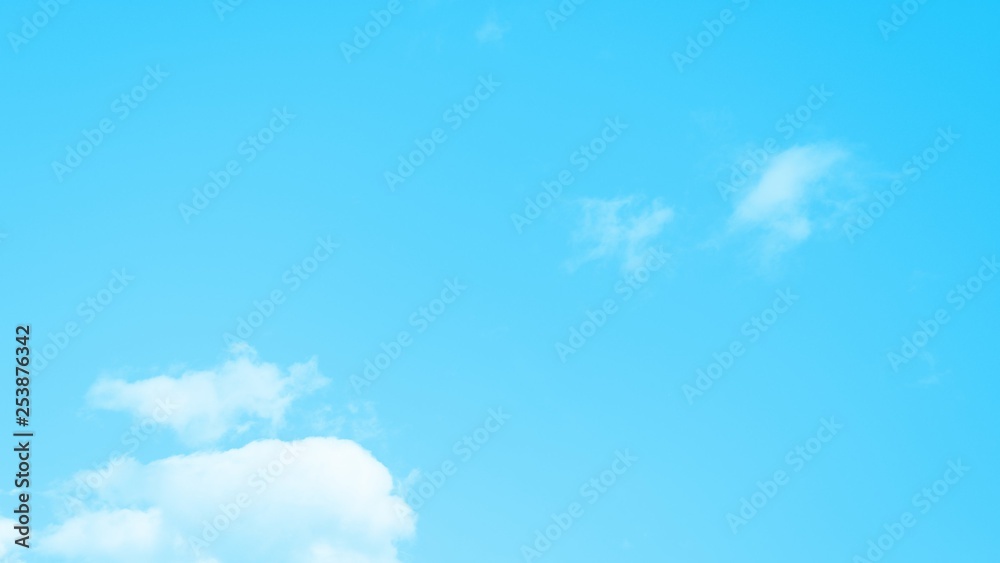 Fluffy white clouds on the clear blue sky background. 16:9 Fluffy white clouds on the clear blue sky background. 16:9