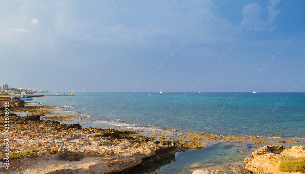 Beach and promenade in Protaras, Cyprus, Mediterranean Sea.  Sea beach relax, outdoor travel. Copy space background - Image