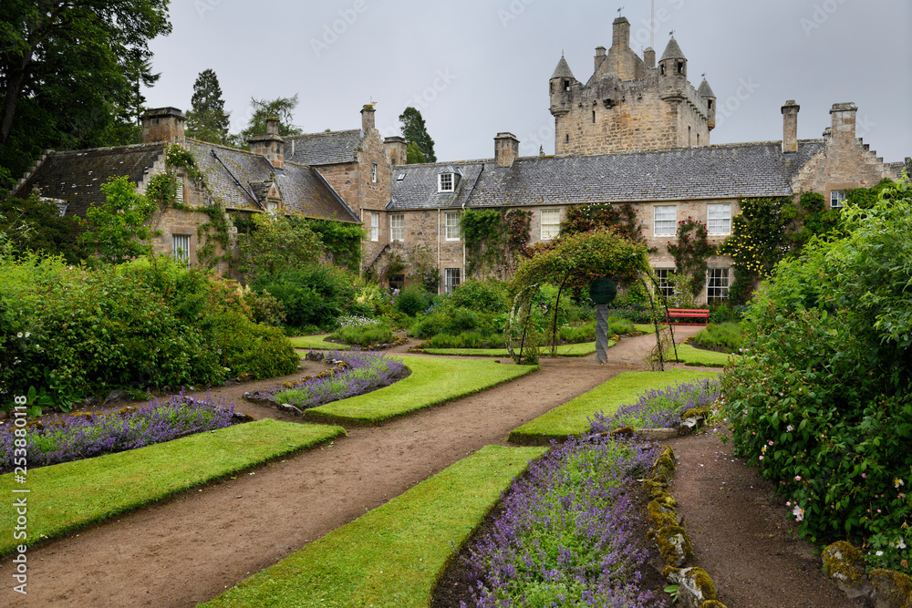 Wet Flower Garden with purple perennial flowers south of Cawdor Castle after rainfall in Cawdor Nairn Scotland UK