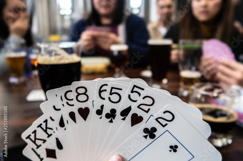 young woman playing cards in brewery