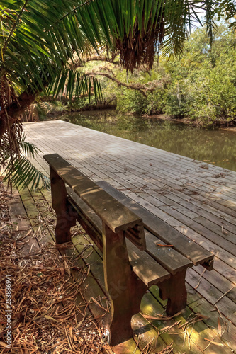 Old dock and bench along the riverway at historic Koreshan State Park. photo