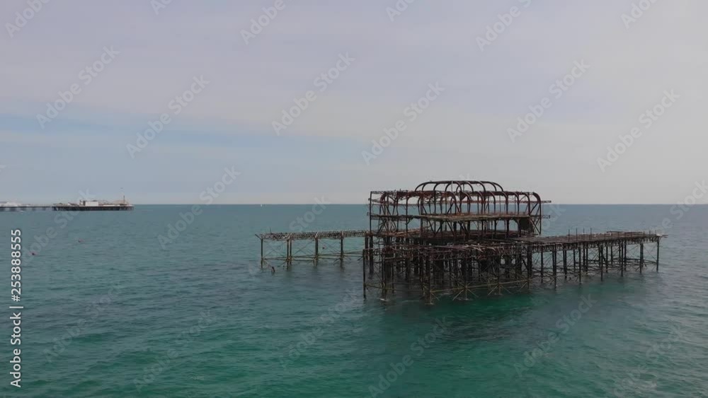 The burnt west pier with the Brighton Palace Pier and Brighton's beach. The burnt west pier with the Brighton Palace Pier and Brighton's beach.