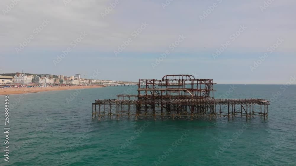 Aerial of Brighton's burnt pier with Brighton's beach and Palace pier in the background. Aerial of Brighton's burnt pier with Brighton's beach and Palace pier in the background.