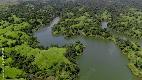 Aerial tilt reveal drone shot of the blue horizon with white clouds over the Bajulmati reservoir in Banyuwangi, East Java Indonesia photo