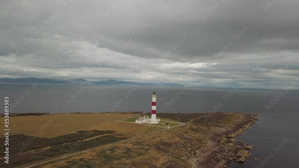 Aerial drone shot of a red and white Lighthouse located in North Scotland Aerial drone shot of a red and white Lighthouse located in North Scotland
