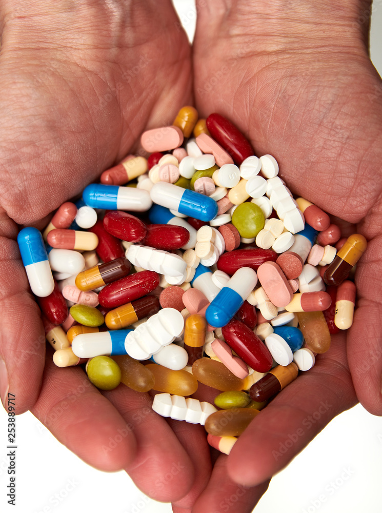 two hands full of tablets and pills two hands full of tablets and pills