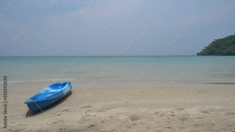 A paddle boat on the beach in a paradise bay with turquoise water. A paddle boat on the beach in a paradise bay with turquoise water.