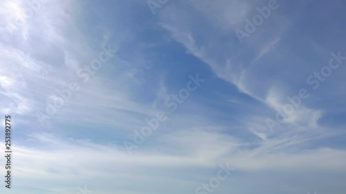 Time-lapse of stratocumulus clouds moving steadily across a blue sky. photo