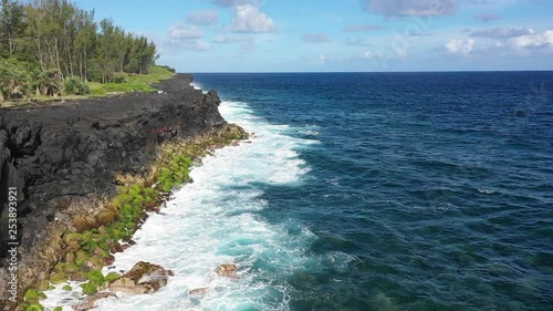 Aerial view over the Lava rock formation of Cap Mechant and the coastline of Reunion Island photo