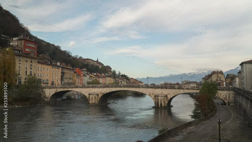Time lapse of a bridge with traffic, French Alps in the background, and the famous cable cars of the city of Grenoble in France. Time lapse of a bridge with traffic, French Alps in the background, and the famous cable cars of the city of Grenoble in France.