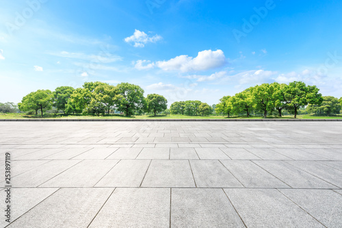Empty square floor and green forest in the city park