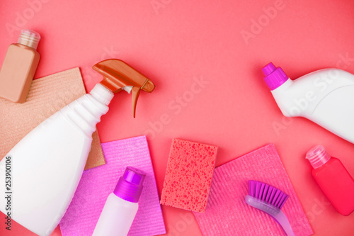 House cleaning products are on pink background.