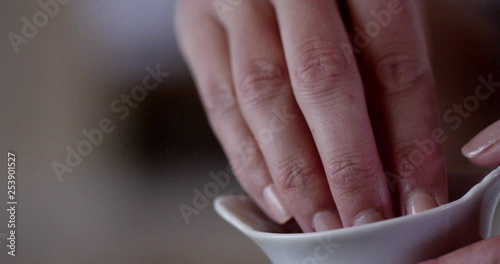 Wallpaper Mural Ground nutmeg is sprinkled into a glass bowl containing ravioli ricotta filling. You can see the fingers pinching the spice and sprinkling it in. Torontodigital.ca