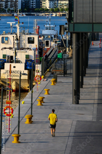 Wallpaper Mural Stockholm, Sweden  A jogger in yellow at the Hammarby shipping lock between the Baltic Sea and Lake Malaren. Hammarby Kaj. Torontodigital.ca