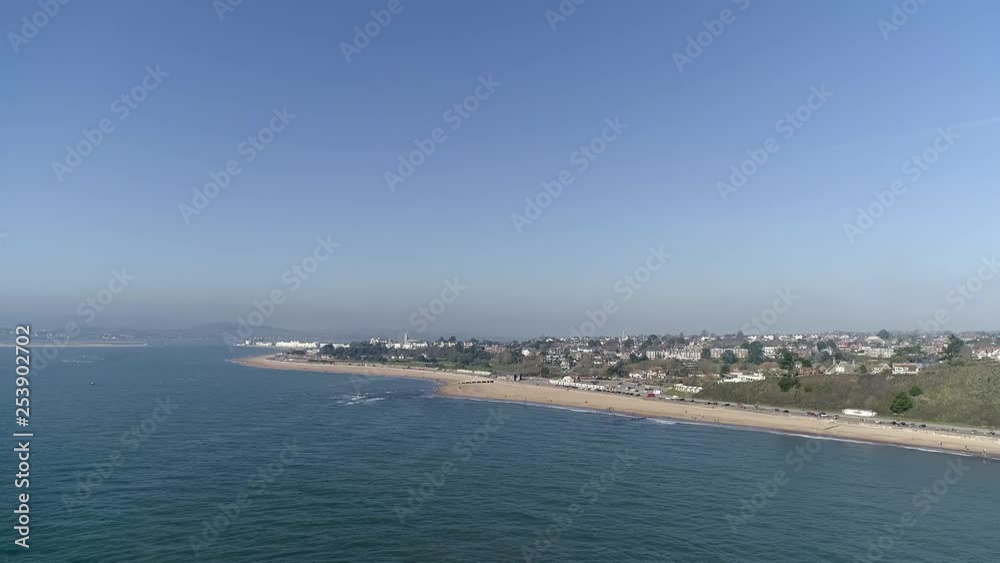 Aerial view of cars driving along the beach front, with beautiful blue ocean Aerial view of cars driving along the beach front, with beautiful blue ocean