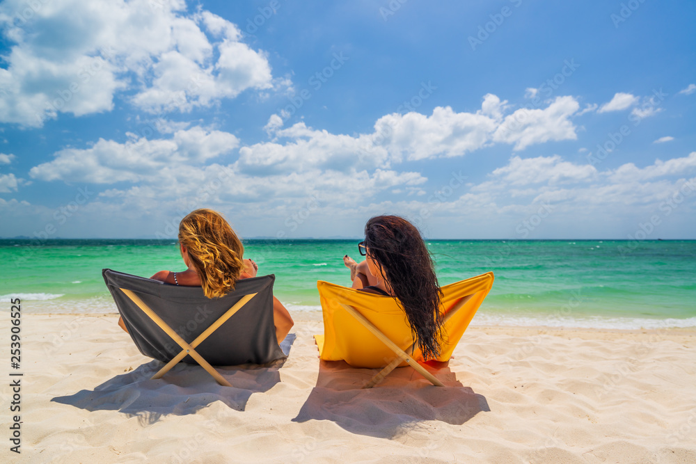 Two Women enjoying their holidays on the tropical beach Two Women enjoying their holidays on the tropical beach
