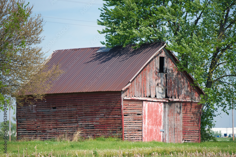 An abandoned barn deteriorates and becomes weathered from non-use in the countryside. An abandoned barn deteriorates and becomes weathered from non-use in the countryside.