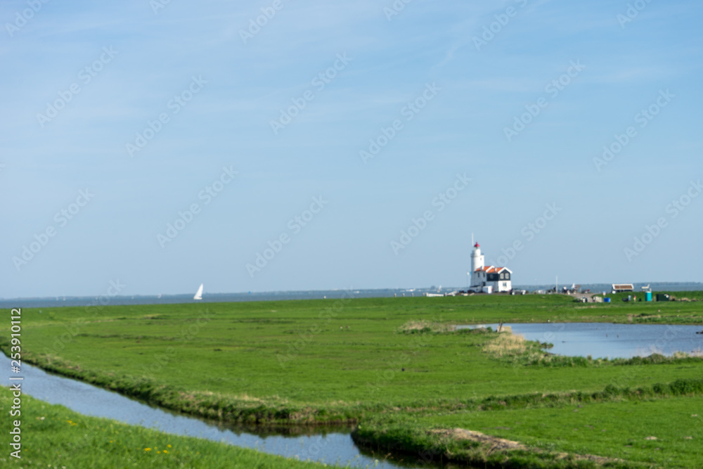 Netherlands,Wetlands,Maarken, a lush green field next to a body of water