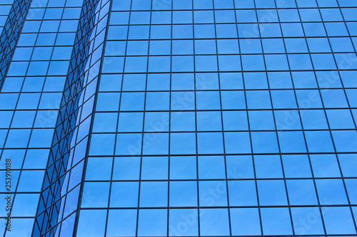 Blue windows reflection on a tall building