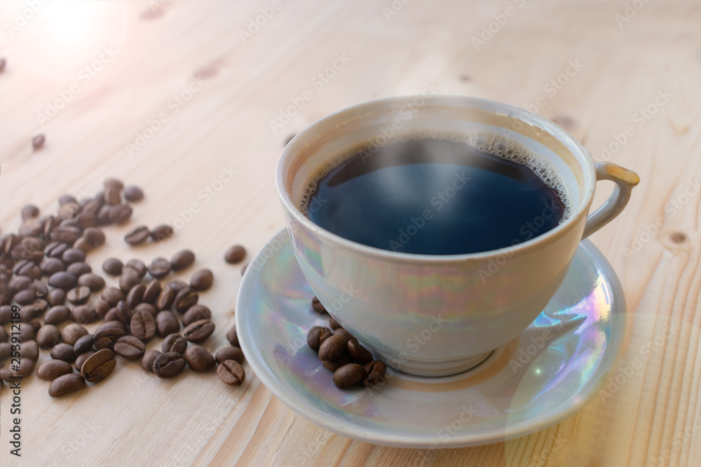 A cup of a black coffee on wooden table A cup of a black coffee on wooden table